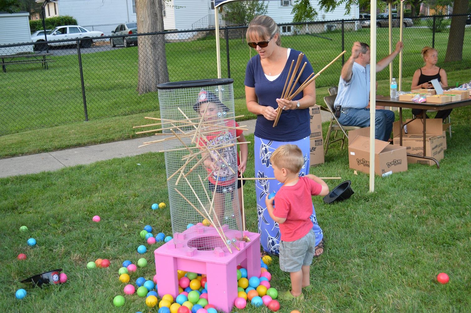 Community members play life-sized Kerplunk at a National Night Out event at the Iowa Community Center, Aug. 2.
